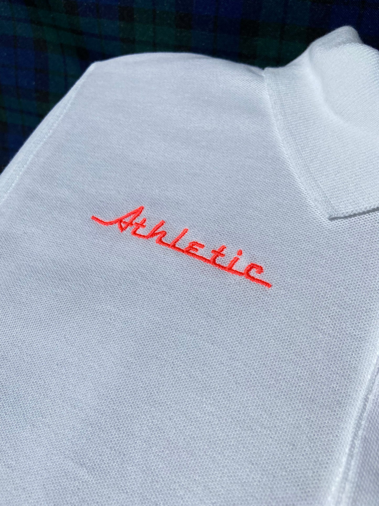 Neon orange/pink Athletic and Affluent: AA Club logo "Athletic" on a vintage white polo